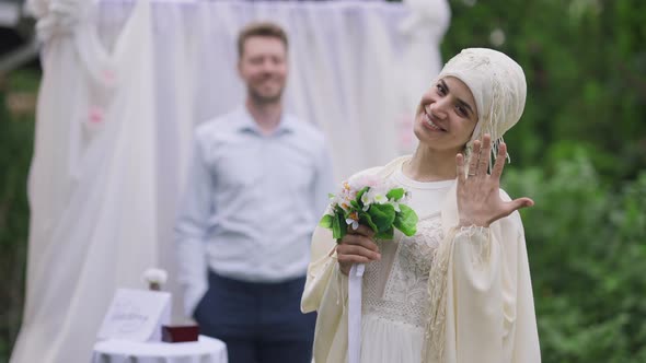 Portrait of Excited Smiling Beautiful Middle Eastern Bride Boasting Wedding Ring on Finger Standing