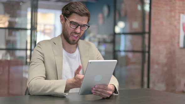 Young Man Reacting to Loss on Tablet