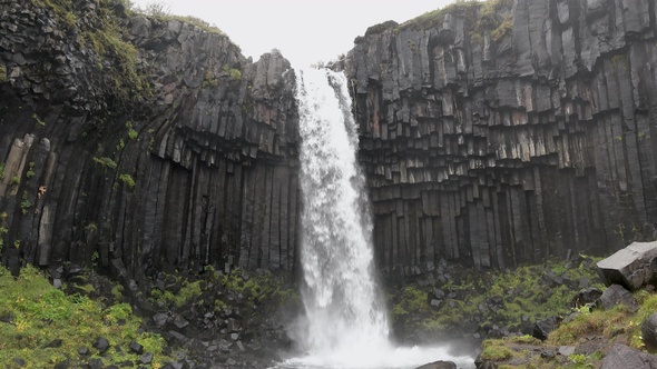 Iceland. Famous Waterfall In Iceland Water Flowing Through High Cliffs Inspiration Epic Scale Nature