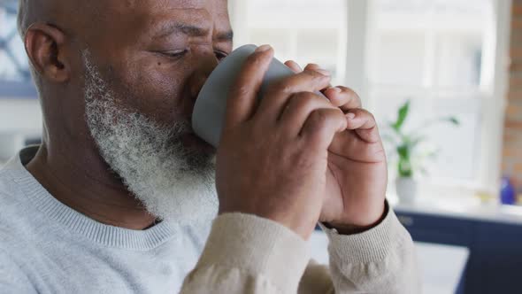 African american man senior man drinking coffee at home