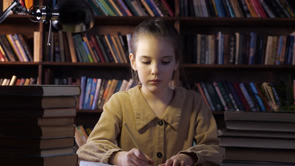 Exhausted Young Lady Writes Home Assignment in Copybook