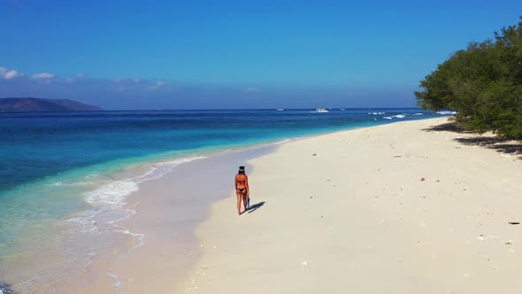 Beautiful ladies happy and smiling on exotic seashore beach lifestyle by transparent sea and white s