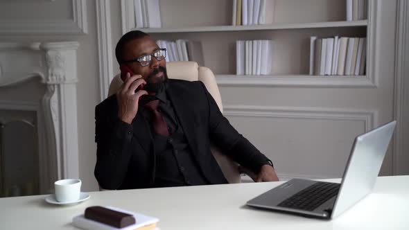 Successful Lawyer Is Working From His Home Office, Talking By Cell Phone