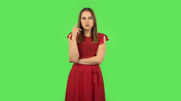 Tender Girl in Red Dress Is Thinking About Something. Green Screen