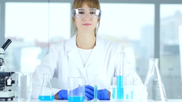 Female Chemist, Scientist Looking At Camera in Clinic