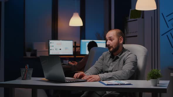 Happy Successful Businessman Smiling While Looking at Laptop Computer