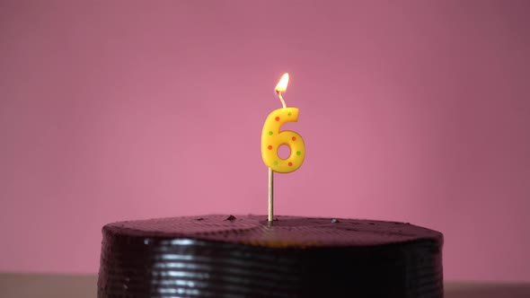 Chocolate Birthday Cake with Wick Lighting Trying to Blowout Candle