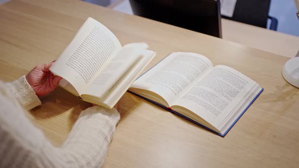 Female Hands Closeup Quickly Flipping Through the Pages of a Paper Book