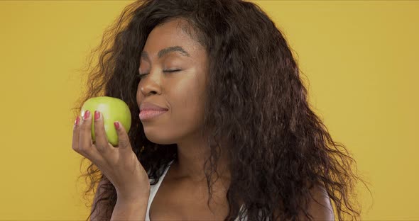 Cheerful Ethnic Woman with Green Apple