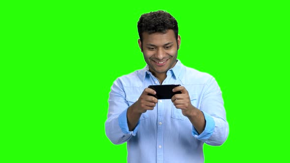 Happy Asian Man Playing Game on His Phone