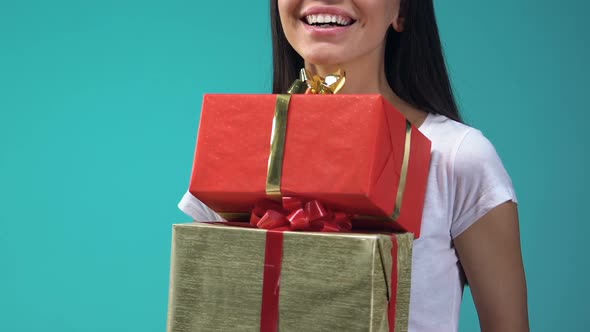 Cheerful Young Lady Holding Gift Boxes, Holidays Presents for Friends and Family