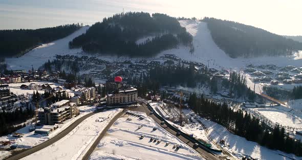 Aerial View of the Ski Resort in Mountains at Winter. Balloon in the Sky Near the Mountain