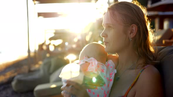 Mom and baby having nice summer day at the beach