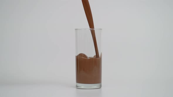 Super Slow Motion of Filling Glass with Chocolate Milk