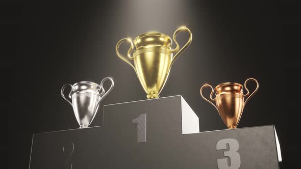 Golden, silver and bronze metallic trophy cups on a podium in the spotlight 4KHD