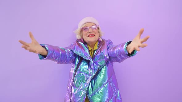 Attractive Energetic Old Lady in Stylish Clothes and Fashionable Sunglasses Poses for the Camera on