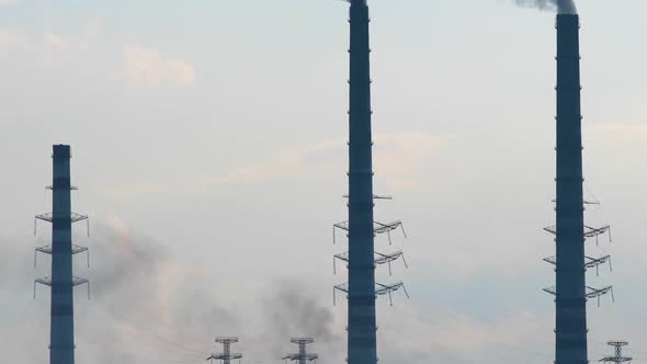 Coal Power Plant High Pipes with Black Smoke Moving Upwards Polluting Atmosphere