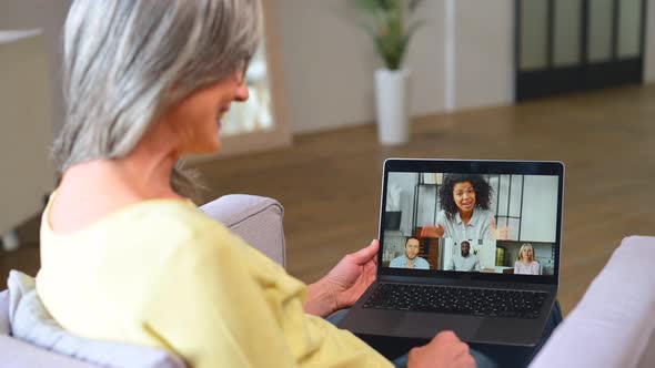 Middle Aged Female Entrepreneur Using Laptop for Video Call