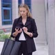 Smiling Businesswoman with Smartphone on Street - VideoHive Item for Sale