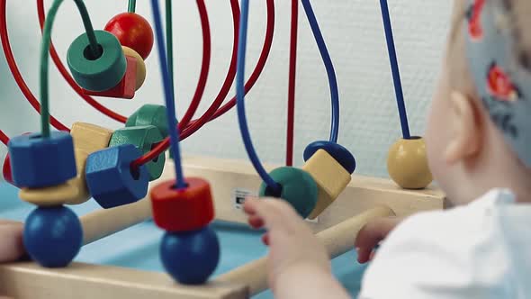 Child Plays with a Multi-colored Toy