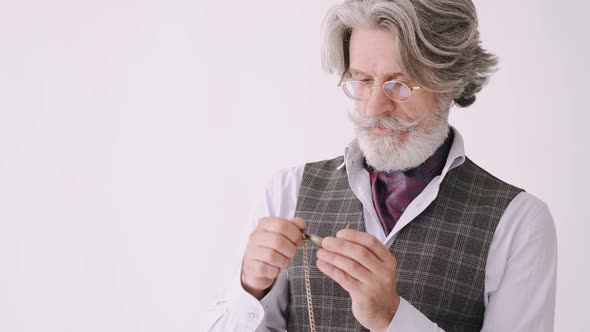 Senior Tylish Man with an Old Hand Watch on White Background