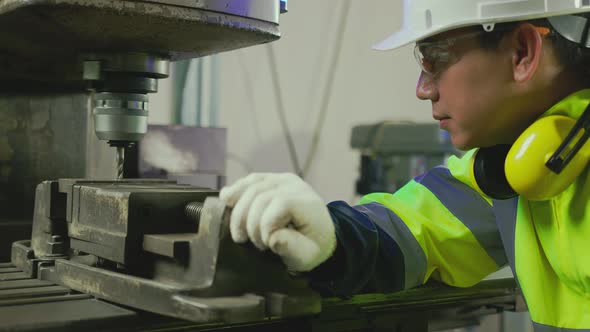 professional asian male engineer specialist worker wearing uniform hand control