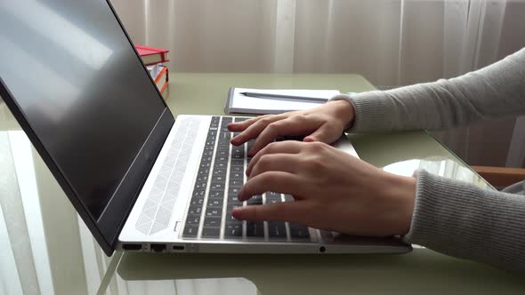 The girl working at home office hands on keyboard