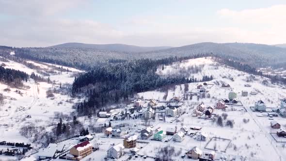 Village with the Buildings Is All Covered with Snow. Aerial View