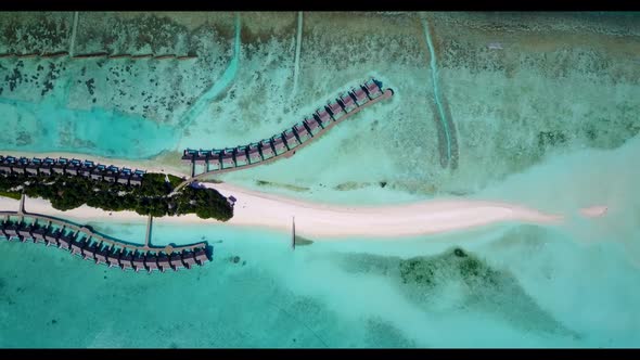 Aerial nature of tranquil tourist beach time by aqua blue sea and white sand background of a dayout 