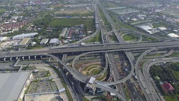 Aerial View of Highway Road Interchange with Busy Urban Traffic Speeding on Road