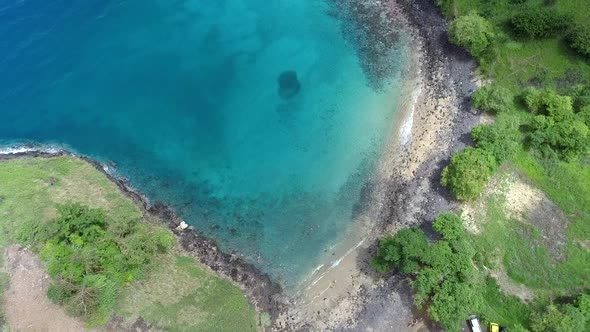 Aerial ascend view tropical Blue lagoon beach, São Tomé Island