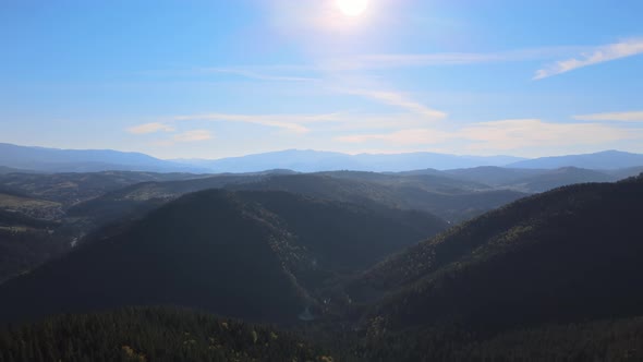 Aerial Landscape View of High Peaks with Dark Pine Forest Trees in Wild Mountains