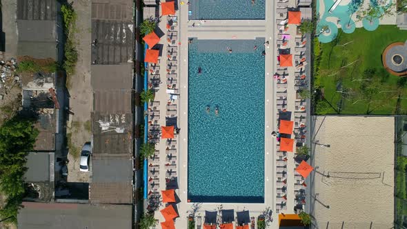 Drone Aerial Top View People Swim in Pool on Territory Residential Complex