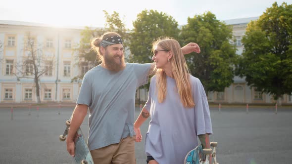 Two Happy Multiracial Couple Friends Giving High Five at Sunny Summer Evening