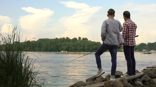 Father and Teenager Son Fishing Together, Relaxing Near Lake, Favorite Hobby