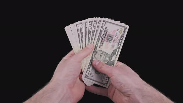 Male Hands Holding a Fan of a Lot of 50 Dollar Bills with Alpha Channel