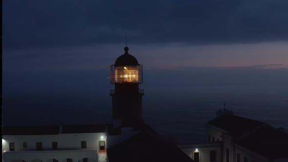 Shining Lighthouse Head Lamp Light at Dusk Drone Circling Around with Background Evening Sea Lagos