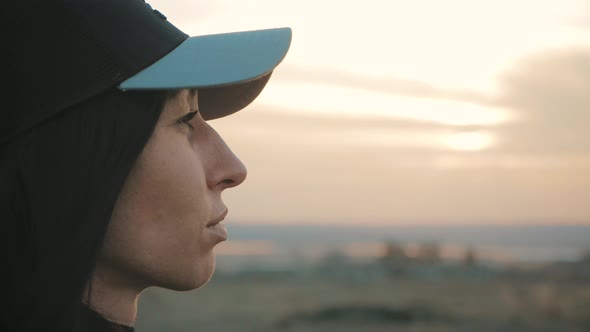 Portrait of Young Woman Looking Up at Sunset Sky