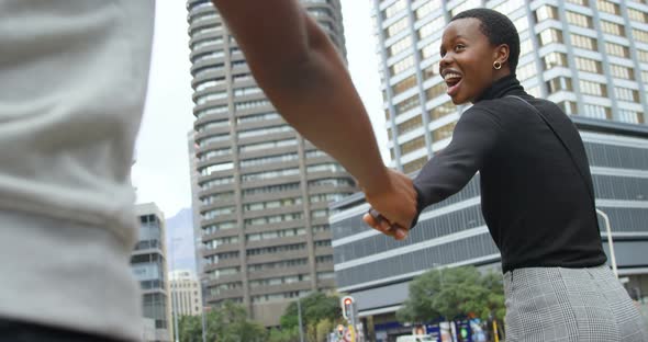 Couple holding hand while walking in city street 4k