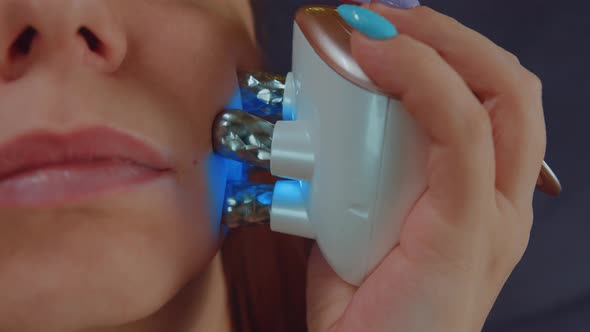 Part of Woman's Face with Face Massager