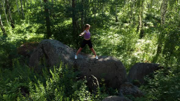 The Girl is Doing Fitness in the Forest