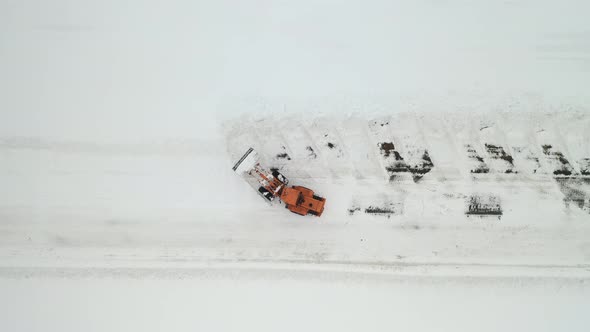 Snow clearing. Tractor clears the way after heavy snowfall