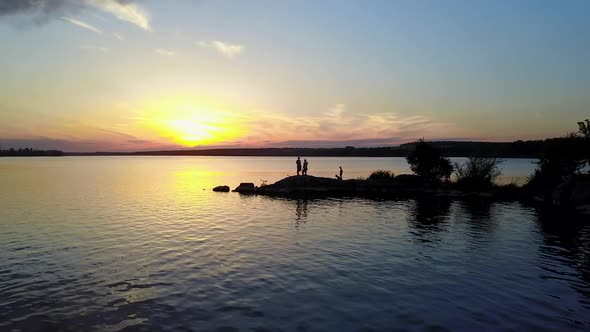 People Enjoying the Riverside Sunset