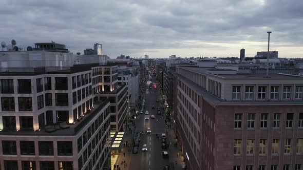 AERIAL: Low View Into Berlin Mitte Friedrichstrasse and Car Traffic City Lights, Subway Train