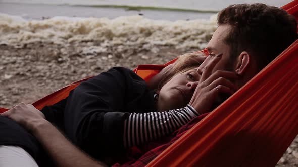 Happy Girlfriend Relaxing with Boyfriend in Hammock