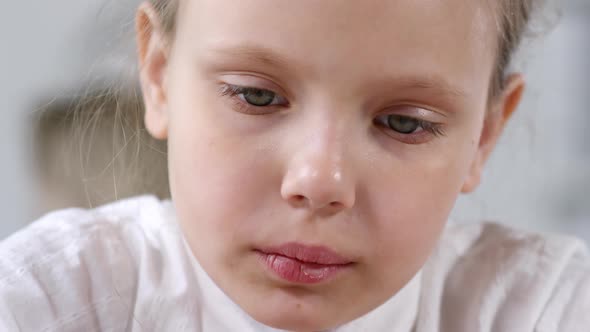 Caucasian Schoolgirl Looking Down, Focused on Task