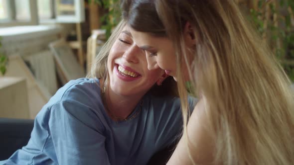 Two Young Pretty Lgbt Ladies are Sitting Together Hugging and Enjoying Each Other