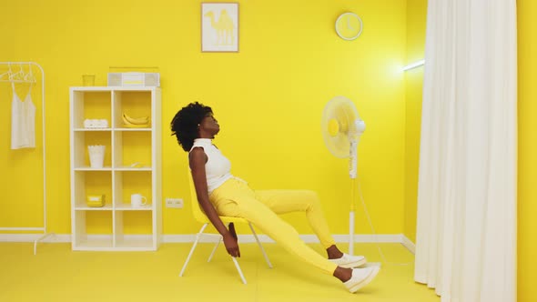 Woman Is Relaxig In Front of Fan