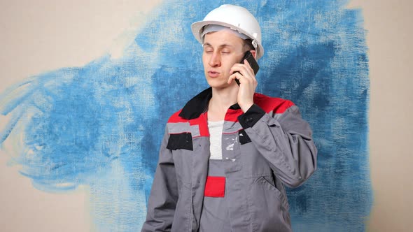 Focused Repairman in Casque Talks to Employer on Phone