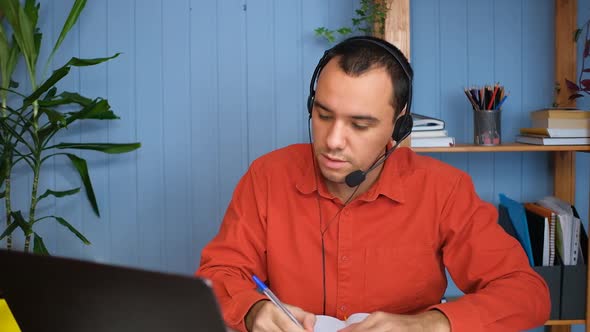 Smiling Young Man Wear Headset Elearning Study with Online Tutor Teacher Talk Conference